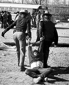 Marcuse being dragged by 2 state policemen