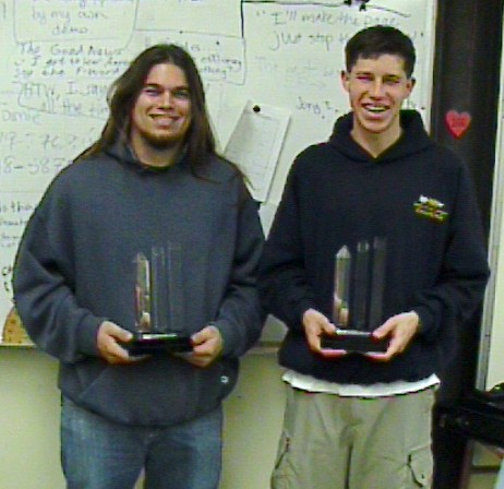 Two team members posting with trophies