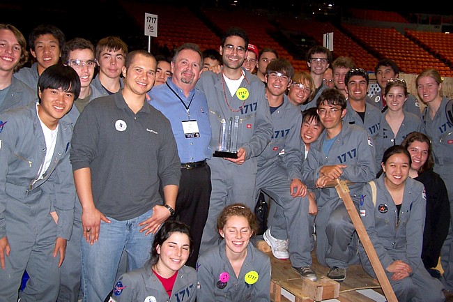 Two team members posting with trophies